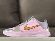 Side profile showing the pink and metallic silver upper, gold Swoosh and gray collar.