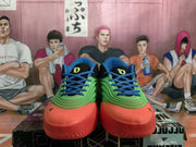Front view of green, blue and red Adidas basketball sneakers with black tongues and blue laces.