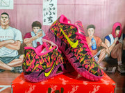 Angled side view showing the patterned Nike basketball sneaker, yellow Swoosh, pink details, and purple outsole.
