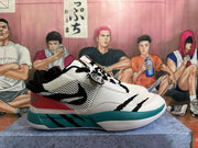 Side view showing mesh-style panels, black graphic details, and a teal midsole