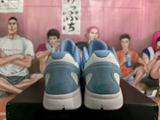 Heel view of blue Nike Kobe basketball shoes with teal accents