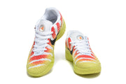 Pair of white, coral, and yellow Nike basketball sneakers shown from the front.
