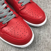 Close-up of the red perforated toe panels and stitched edge detailing.