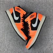 Pair of black and orange mid-top sneakers shown from above at an angle.