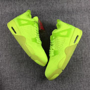 Pair of fluorescent green Air Jordan 4 sneakers shown from opposite side angles.