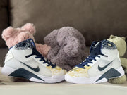 Pair of high-top basketball shoes showing the patterned collars and navy laces.