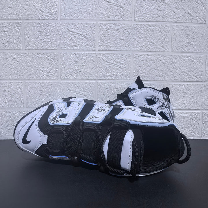 Nike Air More Uptempo sneakers shown from above in black and white with panda graphics.