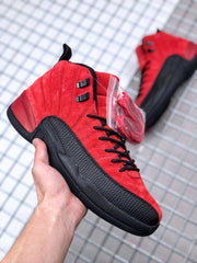 Angled side view of the red and black sneaker with a separate red lace set in a clear bag.