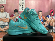 Pair of lake-blue Nike Kobe basketball shoes showing the side panels, laces, and gold-tone Swoosh.