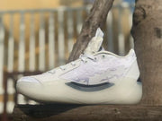 Side view highlighting the patterned upper, black accent, and translucent outsole