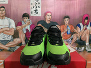 Front view of black and bright green Nike Air Max sneakers with black laces and green toe panels.