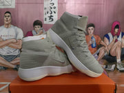 Light gray high-top sneakers shown from the side, with lace-up fronts and white ribbed soles