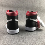 Rear view of the red, black, and white high-top sneakers showing the padded collars, textured black panels, white midsoles, and black outsoles.
