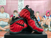 Angled view of two red and black Nike high-top sneakers showing the sculpted side panels, black collars, and black outsoles.
