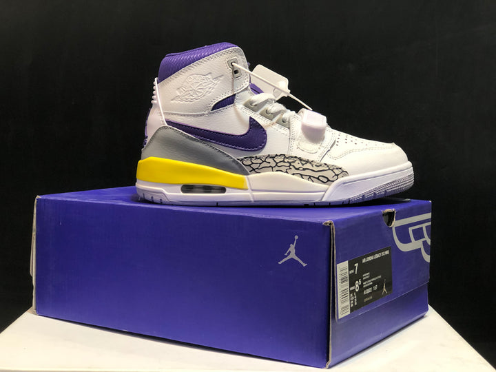 Side view of a white, purple, yellow, and grey Jordan high-top sneaker displayed on a purple shoe box; the box label is visible.