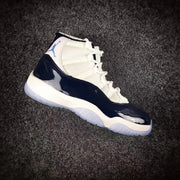 Side view of one navy and white high-top sneaker with its translucent outsole visible.