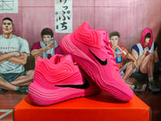 Angled view of a pair of pink basketball sneakers with black Swooshes and layered side detailing.