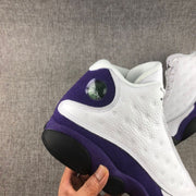 Close-up of the heel with a circular detail, white panel, and purple trim