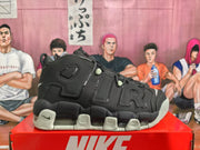 Side profile of a black Nike basketball sneaker with layered panels, perforated details, large AIR-style lettering, and a segmented sole.