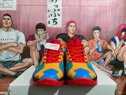Front view of the Nike basketball sneakers showing multicolor patterned toe boxes, red laces, and red outsoles.