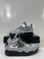 Pair of gray and black Air Jordan 4 Retro sneakers shown from a side angle with silver-tone lace hardware.