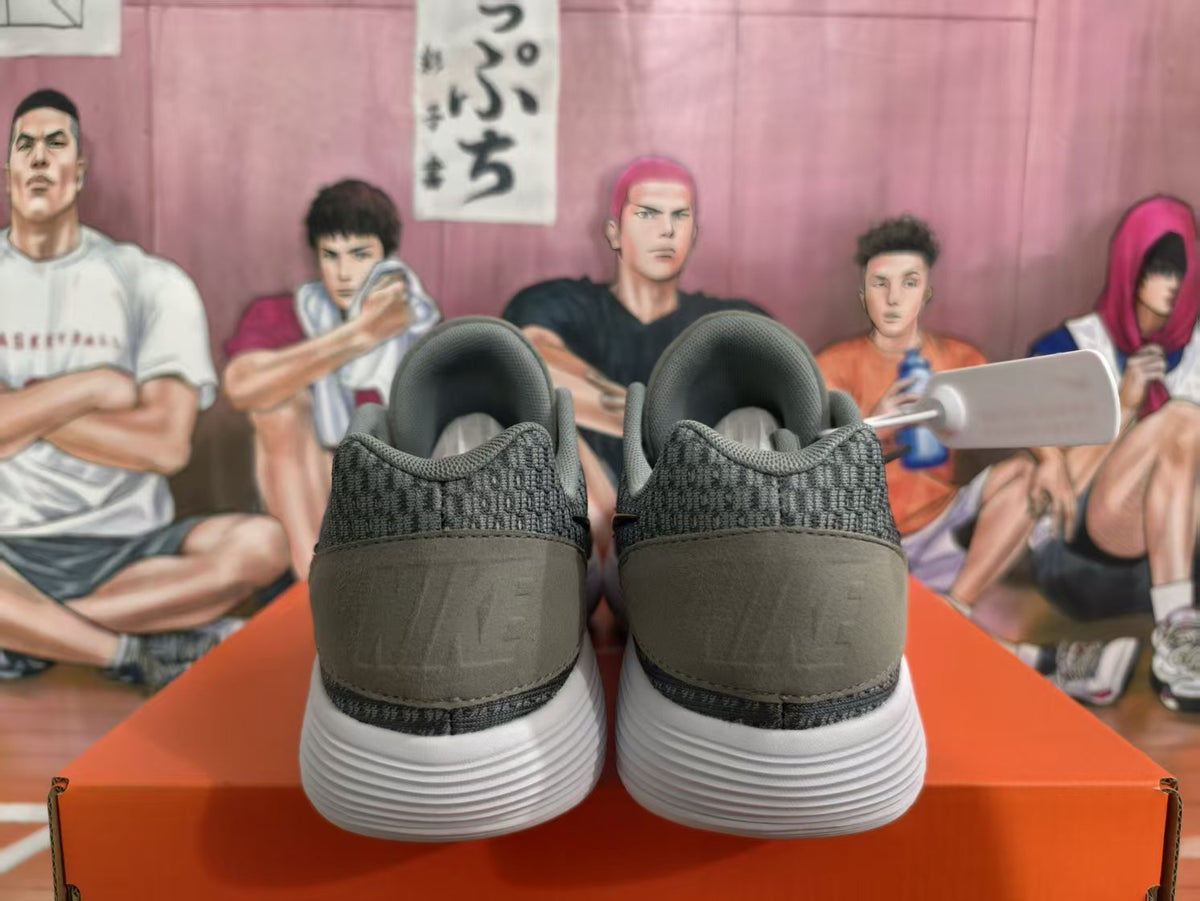 Rear view of grey and black Nike KD basketball sneakers showing padded collars, heel panels, and white sculpted outsoles.