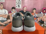 Rear view of grey and black Nike KD basketball sneakers showing padded collars, heel panels, and white sculpted outsoles.
