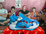 Side view of a blue Nike basketball sneaker showing the graphic toe panel, red swoosh accent, white midsole, and blue outsole.