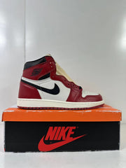 Side profile of the high-top sneaker showing the red toe and heel, white side panel, and black Swoosh.