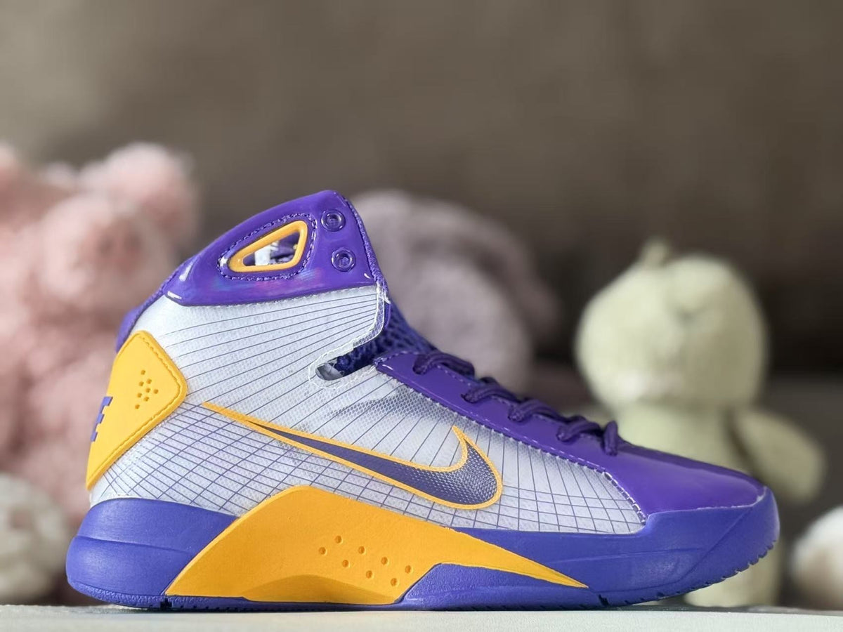 Side view of a purple, silver, and gold high-top kids basketball sneaker with a visible Swoosh.