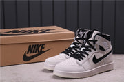 Pair of sneakers displayed in front of a Nike-branded shoebox.