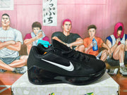 Side view of a black Nike sneaker with a white swoosh and glossy black sole.