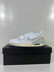 Side profile of the white and silver Jordan Legacy 312 Low sneaker with an ankle strap and layered sole.