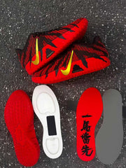 Pair of brown and red sneakers with gold Swoosh branding and separate red, white and gray sole components.