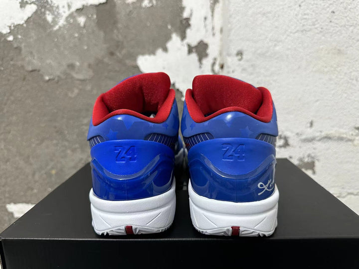 Rear view of blue Nike Kobe basketball shoes with red lining, star details, and white midsoles.