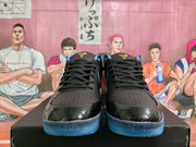 Front view showing paired black basketball sneakers with perforated toe areas, black laces, and translucent blue soles.