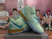 Pair of mint green Nike basketball sneakers with blue accents and gold-toned midsoles displayed on a box.