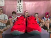 Front view of red and pink basketball shoes with red laces