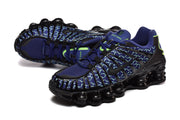 Angled view of blue patterned Nike Shox TL sneakers with black detailing.