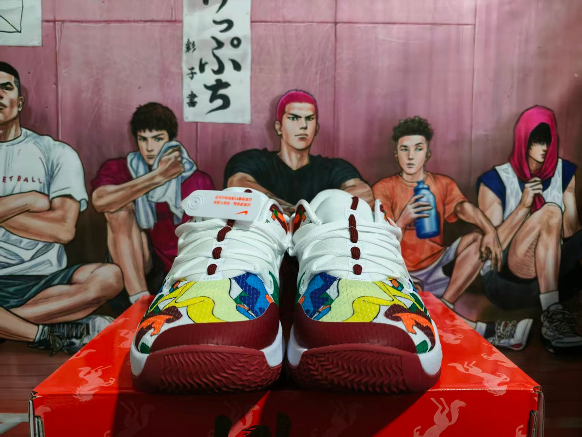 Front view of white and burgundy Nike Ja 1 basketball shoes with multicolor patterned toe overlays.