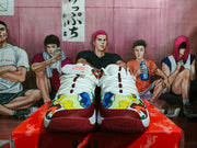 Front view of white and burgundy Nike Ja 1 basketball shoes with multicolor patterned toe overlays.