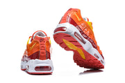 Rear and outsole views of orange and red Nike Air Max 95 TT sneakers