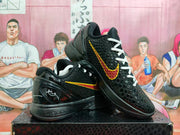 Pair of black Nike basketball shoes with textured uppers and red-and-yellow Swoosh accents