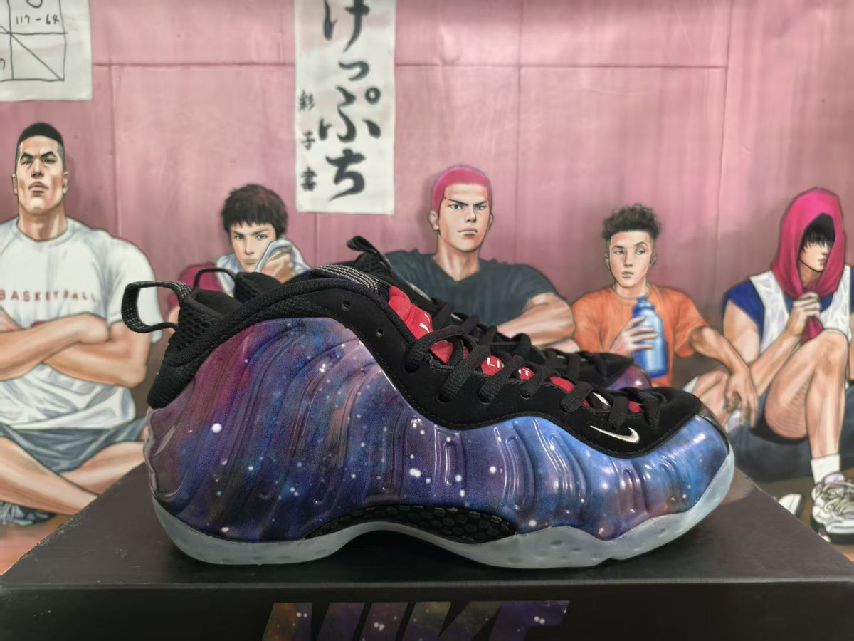 Side view of a galaxy-patterned purple and blue Nike basketball sneaker with black laces and a translucent sole