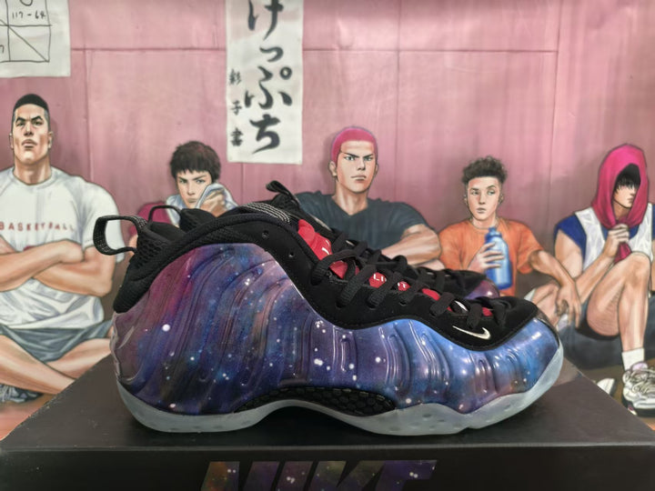 Side view of a galaxy-patterned purple and blue Nike basketball sneaker with black laces and a translucent sole