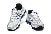Front views of a pair of silver Nike Shox Ride 2 sneakers with blue and black accents.
