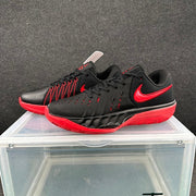 Pair of black Nike Kyrie 7 basketball shoes with red Swooshes, shown from the side.