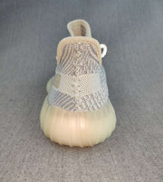Rear view showing the knit heel, padded collar, pull tab, and cream-toned sole.