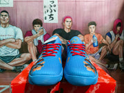 Front view of blue Nike basketball sneakers showing red laces, textured uppers, and multicolor graphic accents.