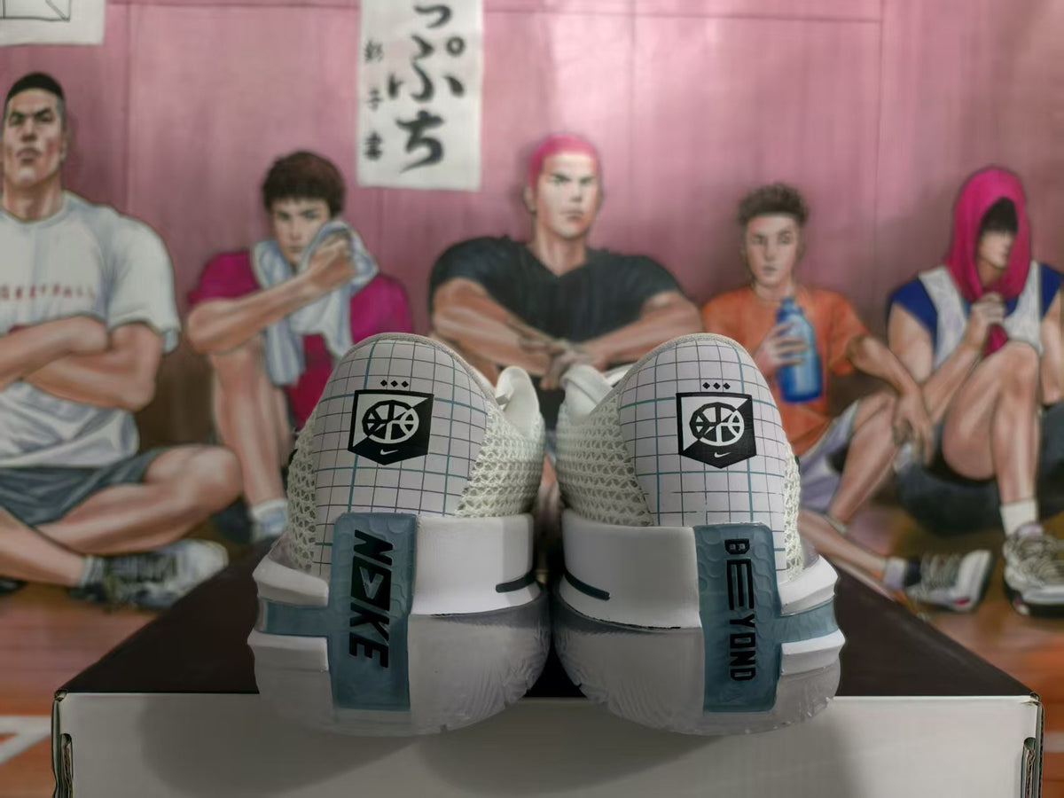 Rear view of white and silver Nike basketball shoes positioned on a shoebox.